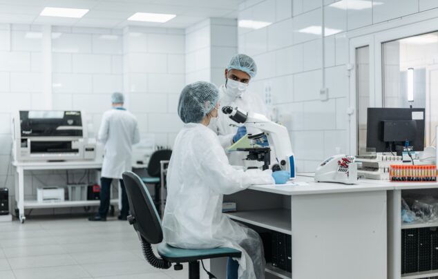 Laboratory scientists conduct research using advanced microscopes in a well-equipped lab.