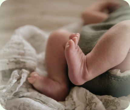 Newborn baby feet on a soft blanket