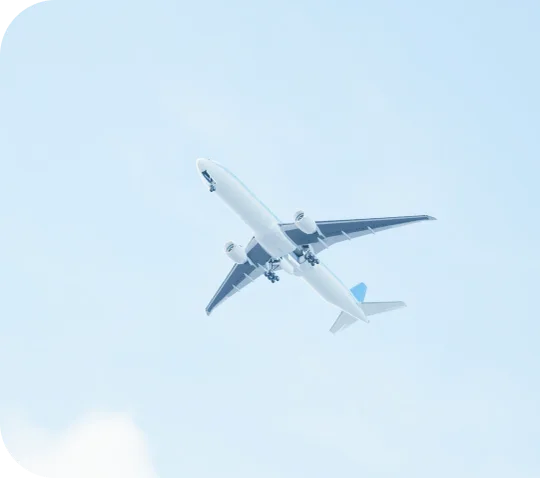 A passenger jet climbing through a clear blue sky