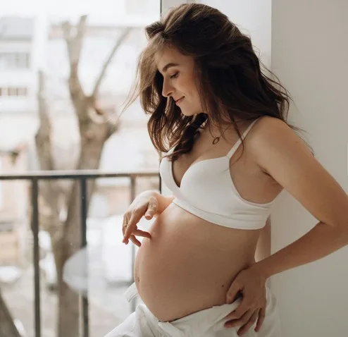 Pregnant woman cradling her belly