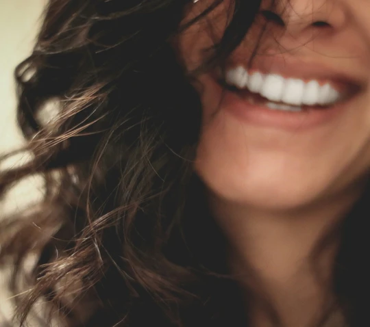A surrogate laughing, hair falling across her face
