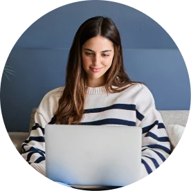 A woman reading the surrogacy requirements guide on her laptop