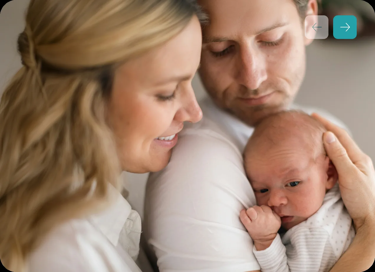 Newborn baby held by caring hands
